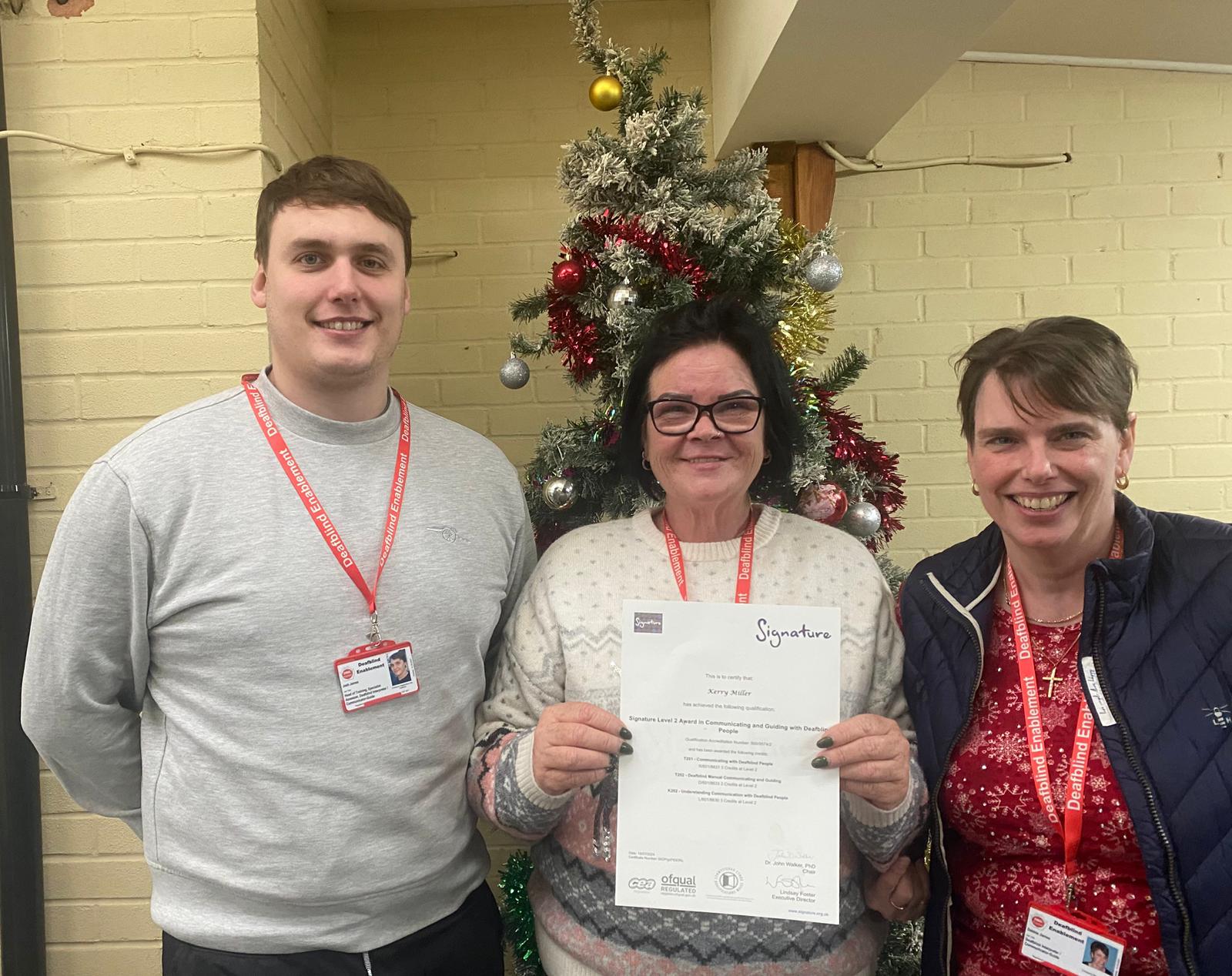 Kerry with her Certificate with Tutor Josh James and Director Debbie James